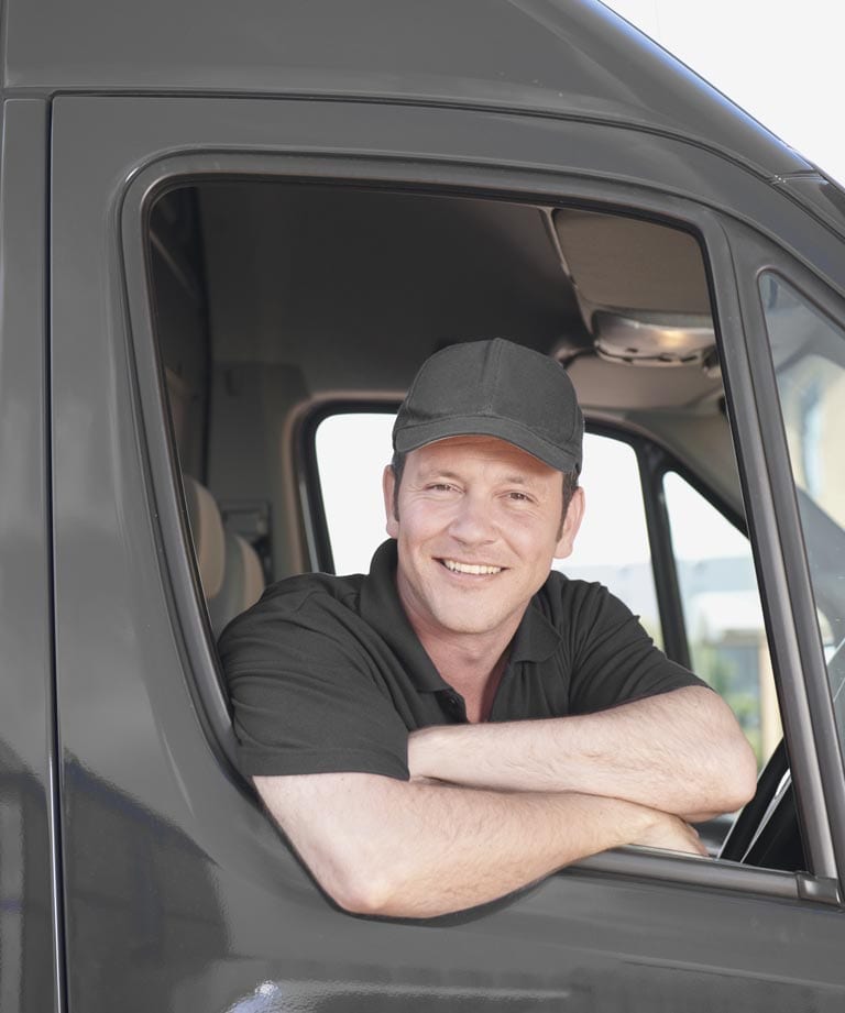 delivery man smiling in van